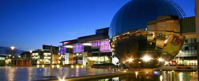 the planetarium on millenium square with a water feature in front of it